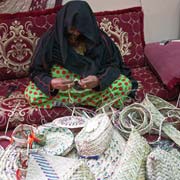 Bedou women weaving baskets